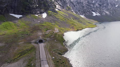 aerial view of lakeside road tunnel through mountain to geirangerfjord in geiranger region in norway