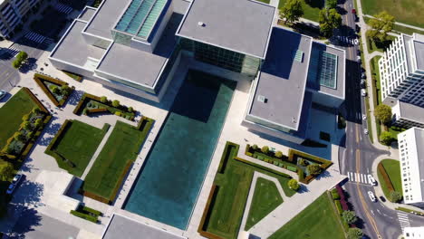 aerial view of modern architectural campus with water feature and gardens