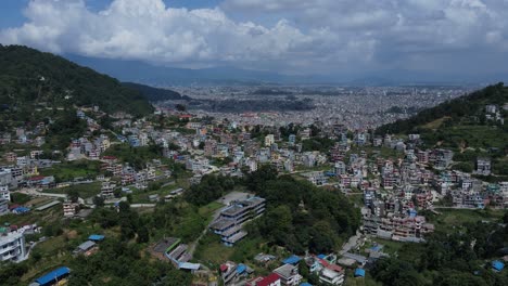 aerial drone footage of kathmandu, nepal’s capital, showcases city life, historic architecture, and scenic skies filled with white clouds—offering a peaceful contrast to the dense urban landscape