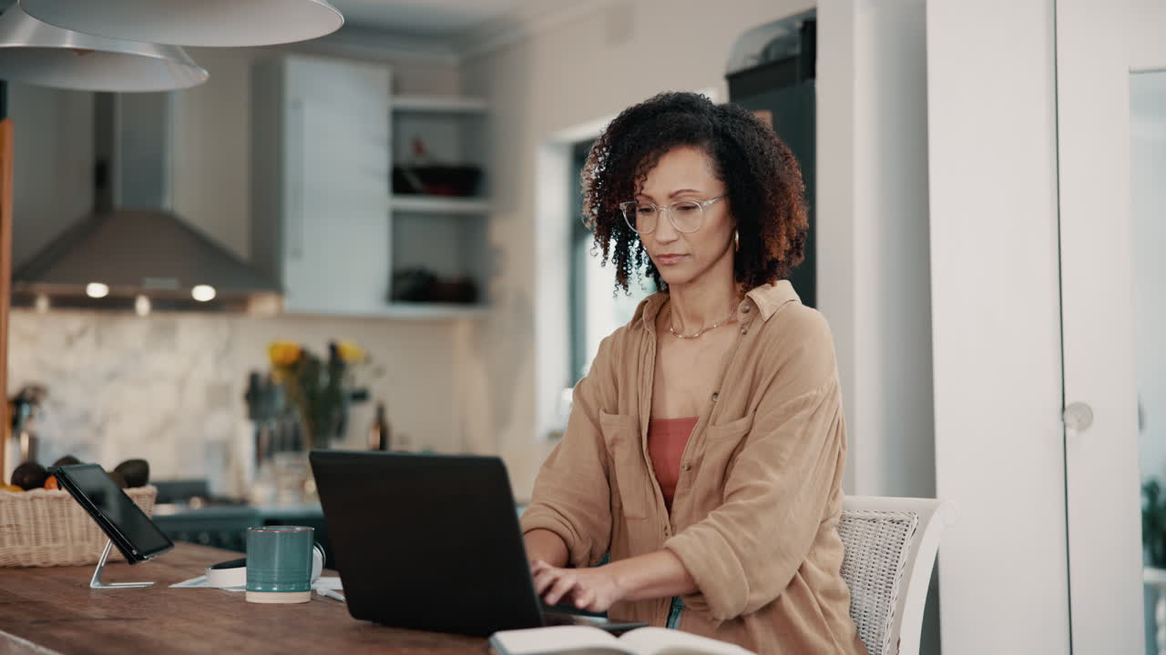 Woman Working from Home on Laptop in Kitchen