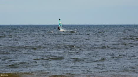 an active windsurfer riding the ocean waves in poland