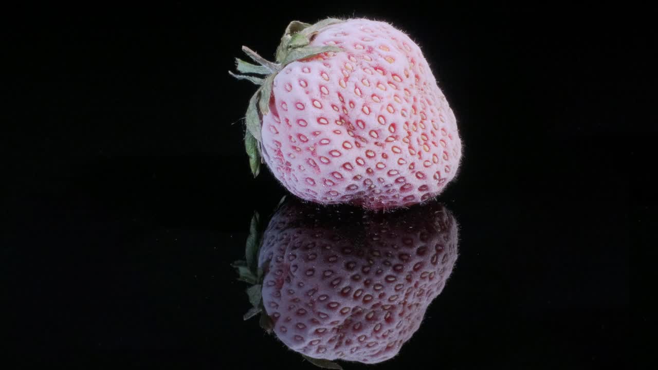 검은색 유리판에 냉동 된 딸기, 검은색 배경, 360도 회전, 클로즈업