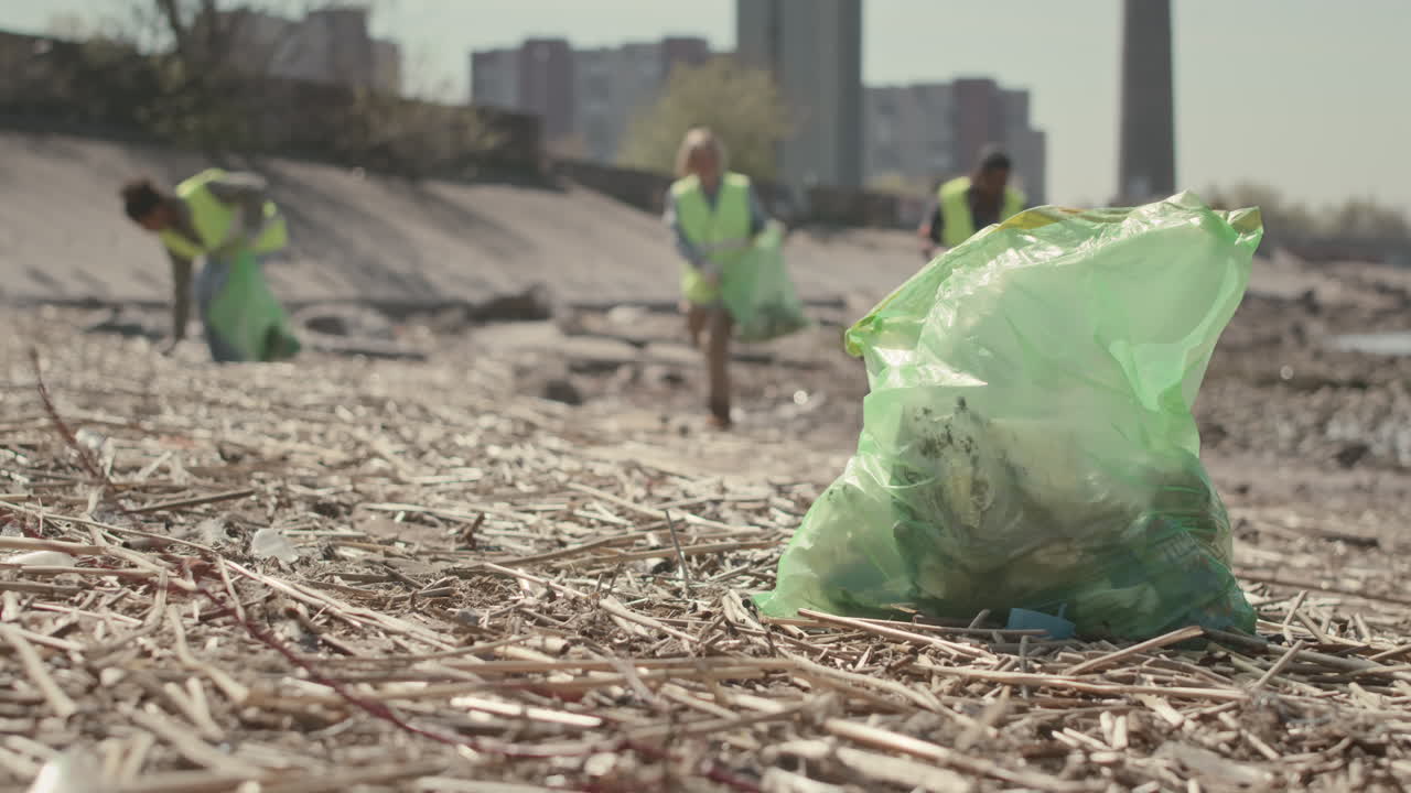 Trash Bag with Waste Collected on Coastline