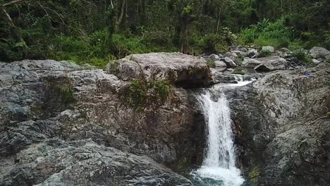 Slow-Motion-Aerial-View-of-Las-Garzas-Waterfall,-Charco-El-Ataud,-Puerto-Rico