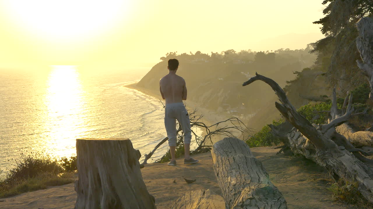 Man Enjoying the Sunset on the Coast