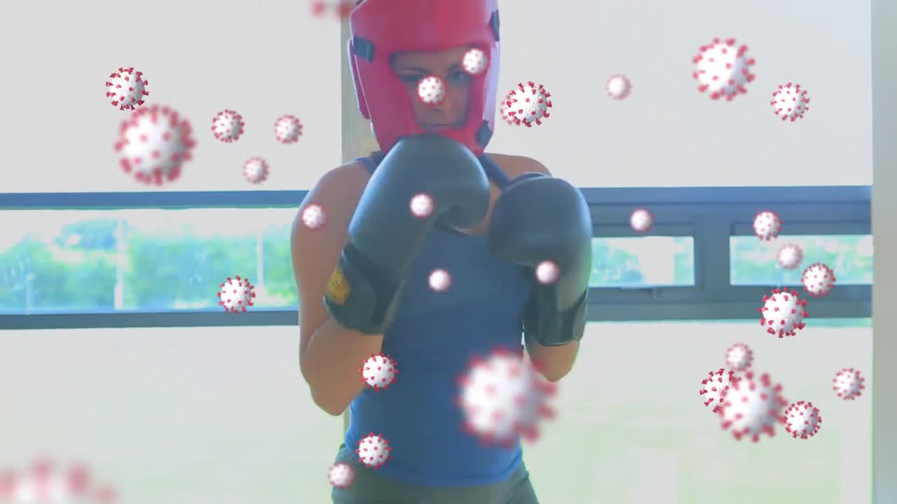 헬 ⁇ 과 권투를 하는 백인 여성 위에 떠다니는 바이러스 세포의 애니메이션