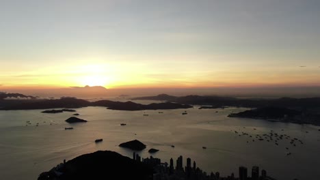 sunset over hong kong bay islands, aerial view facing the setting sun