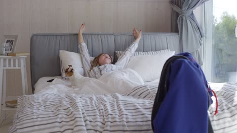 happy woman waking up in morning and petting dog