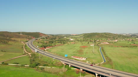 Aerial:-A-highway-going-through-the-country-side-of-the-Algarve-in-Portugal