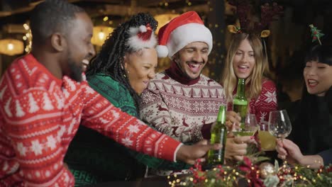 Tracking-Shot-of-a-Group-of-Friends-Celebrating-Christmas-at-Bar