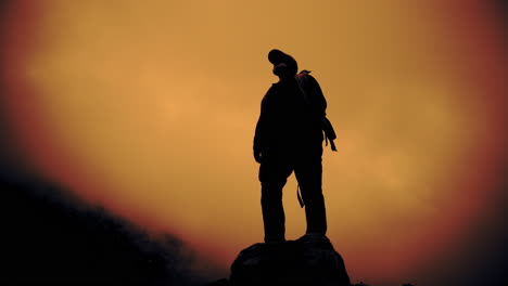 silhouette of a hiker on a mountain at sunset