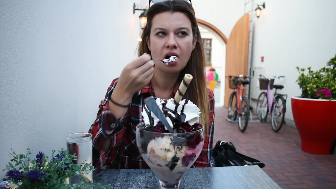 Una mujer comiendo helado.