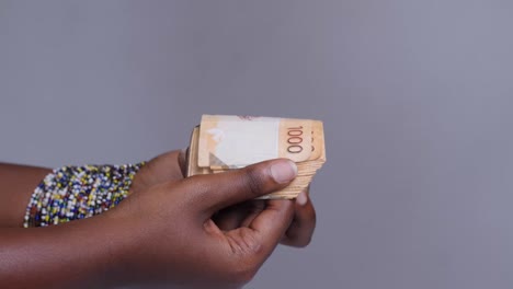 woman counting kenyan shillings