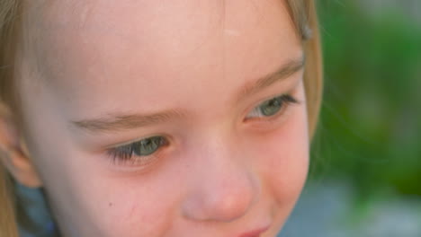 beautiful slow motion portrait of a smiling, blue-eyed little girl