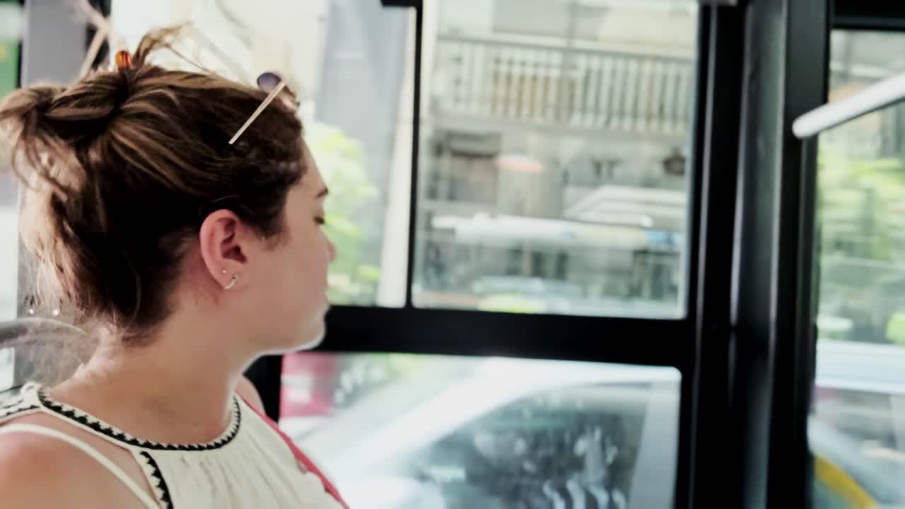 Tourist Woman Looking Out Bus Window While Traveling in Athens