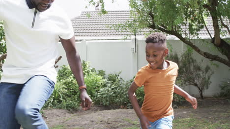 African-American-father-and-son-enjoy-a-playful-run-outdoors