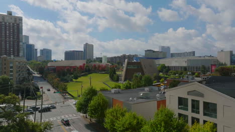 Aerial-ascending-footage-of-public-park-and-modern-design-buildings-in-city