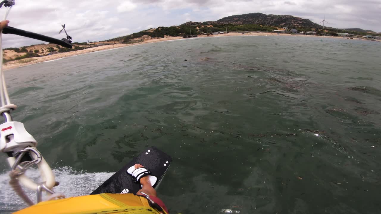 Beautiful first person pov shot of kitesurfer riding through polluted sea kitesurfing with kitesurf