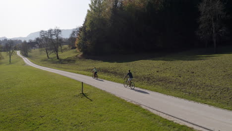 couple of cyclists touring and exploring a landscape by bicycle, aerial shot