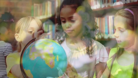 Animation-of-leaves-over-diverse-schoolchildren-looking-at-globe