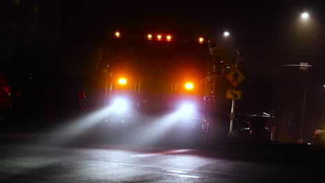 a firetruck turning on its lights on a dark foggy morning in california