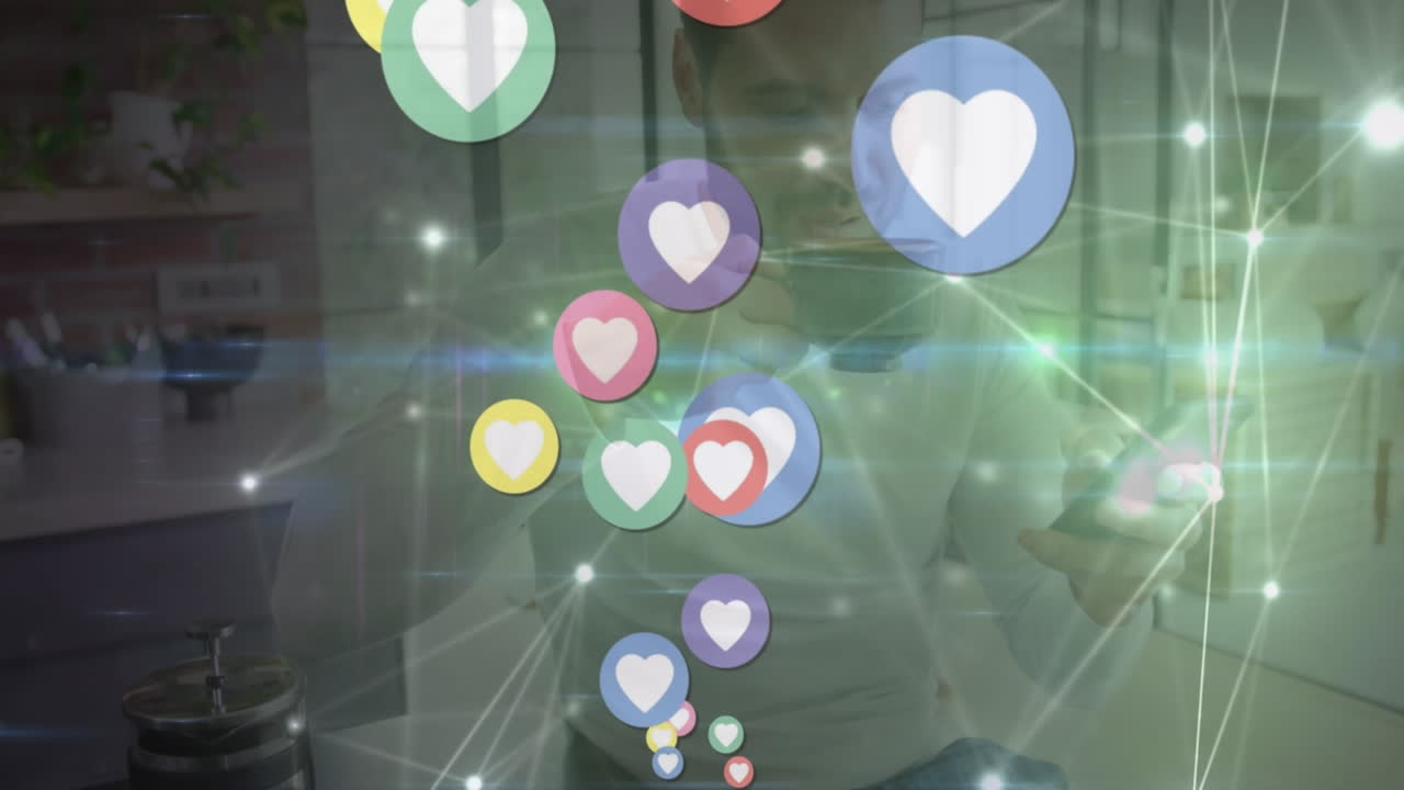 animación de iconos de corazón sobre un hombre caucásico bebiendo café y usando un teléfono inteligente en casa