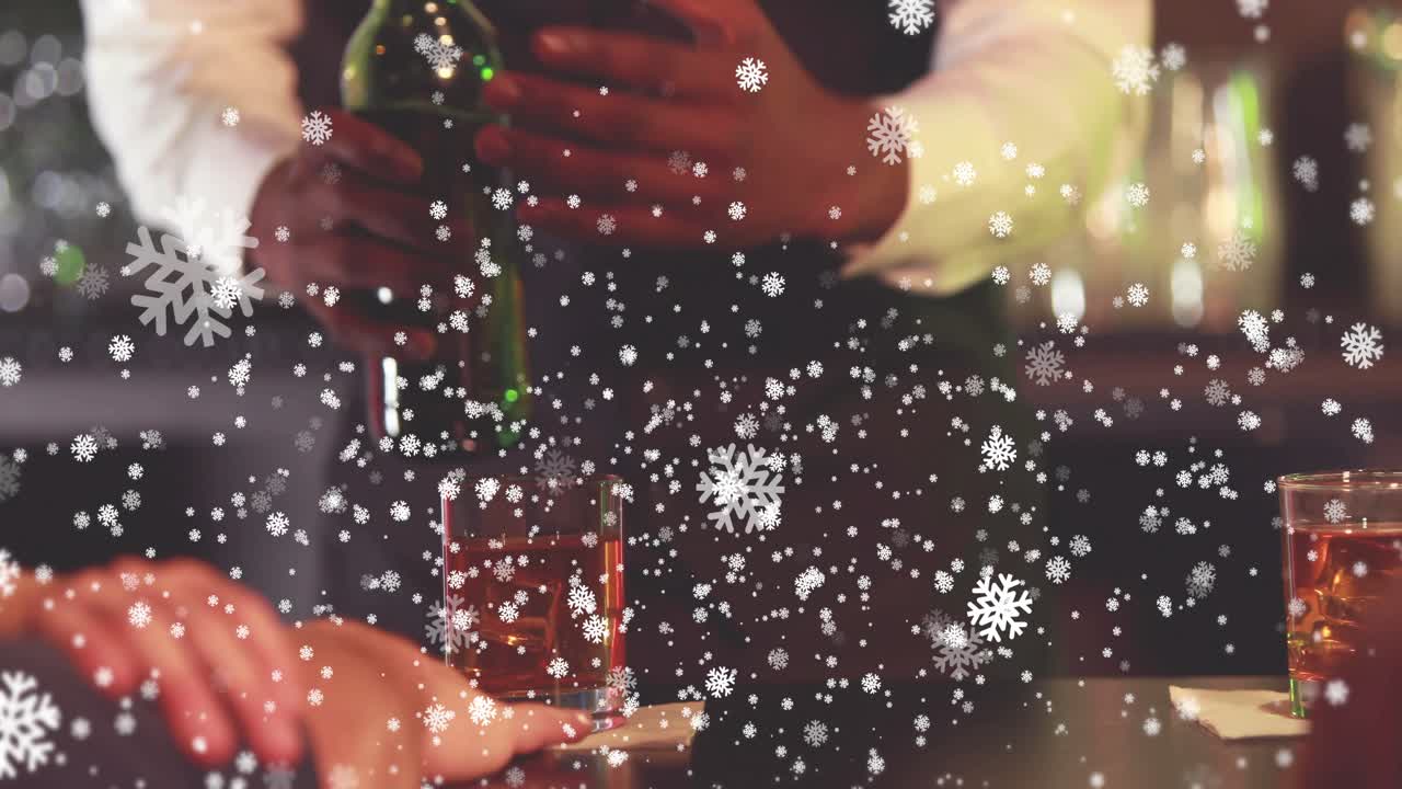Bartender putting down shaker, pouring into glass over ice, snow overlay across bar serving guests