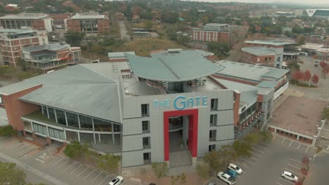 drone aerial of a winged roof on a shopping centre building