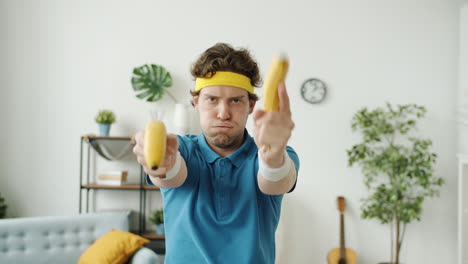 Man Holding Bananas Like Game Controllers