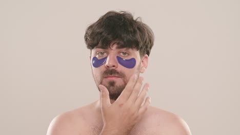 man applying eye patches