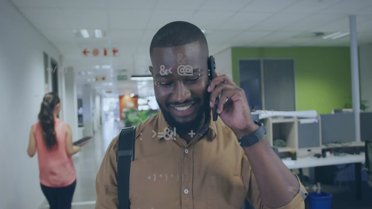 Receiving phone call, man walking to workspace, grabbing binder, tech data overlays growing