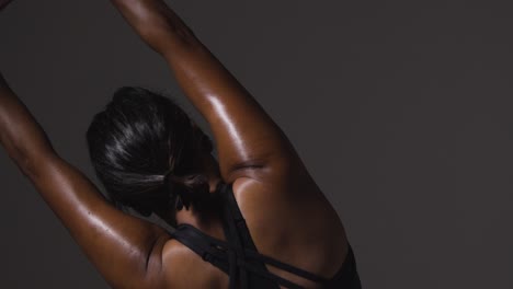 Close-Up-Studio-Shot-Showing-Back-Of-Mature-Woman-Wearing-Gym-Fitness-Clothing-Doing-Stretching-Exercises-4