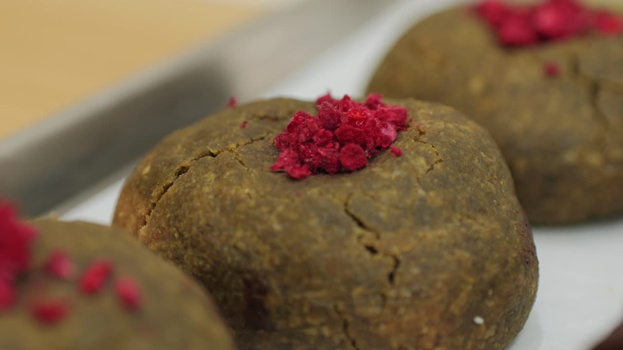 Fresh dessert with green matcha s in bakery shop close-up. Artisan sweets and bread is making by skill bakers using natural and high-quality ingredients. Food with health and flavour benefits. Sweet bio dessert and breakfast. Bakery shop and market