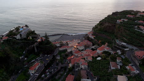 Madeira-architecture,-evening-aerial-overview-of-idyllic-village-houses-of-Ponta-do-Sol,-Portugal