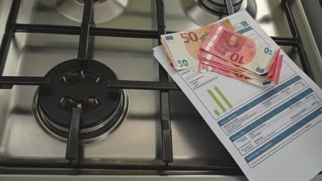 gas burner on and in the background 10 euro banknotes being pulled out. the concept of a steep rise in gas prices