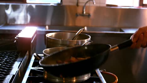 Hand-of-chef-preparing-food