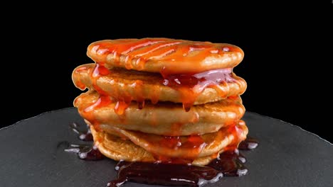 pancakes with strawberry topping. pancake lies on a black slate round stone. alpha channel included.