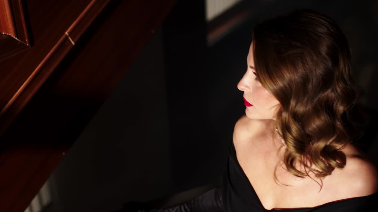 a mysterious and beautiful woman in an evening dress and high heels climbs the stairs into the smoky room