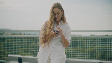 woman browsing smartphone outdoors