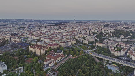 prague czechia aerial v119 flyover park folimanka capturing historical church and chapel, busy traffics on nuselsky most streets and new town cityscape at dusk - shot with mavic 3 cine - november 2022