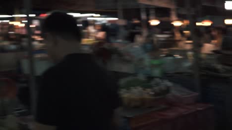 merchant wrapping flowers for customer in market, krabi, thailand, slow motion