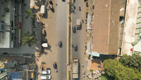 Bird's-eye-view-top-down-rising-from-bustling-street-in-Mumbai-India,-aerial