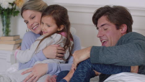 happy family with children jumping on bed playing with mother and father having fun on weekend morning excited little kids enjoying game with parents at home 4k footage