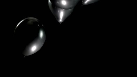 watch as black balloons falls slowly, creating a striking contrast against a clean background. its smooth, controlled descent captures attention, offering a minimalist and captivating visual effect.