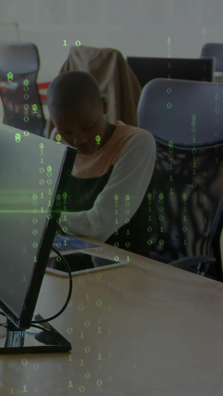 Vertical video: Green binary overlay appearing, woman leaning, using tablet, checking data for work