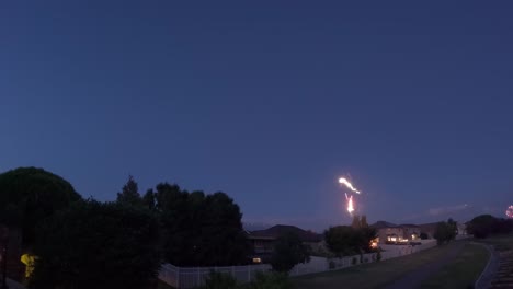 El-Tiempo-De-Los-Fuegos-Artificiales-Del-Crepúsculo-A-La-Oscuridad-Pasa-Sobre-Un-Barrio-Suburbano