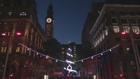 spectaular large christmas tree pan down shot with crowd surrounding and water fountain at martin place in sydney australia