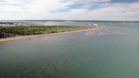 beach at the coastal village of calshot where southampton water meets the solent in hampshire, uk