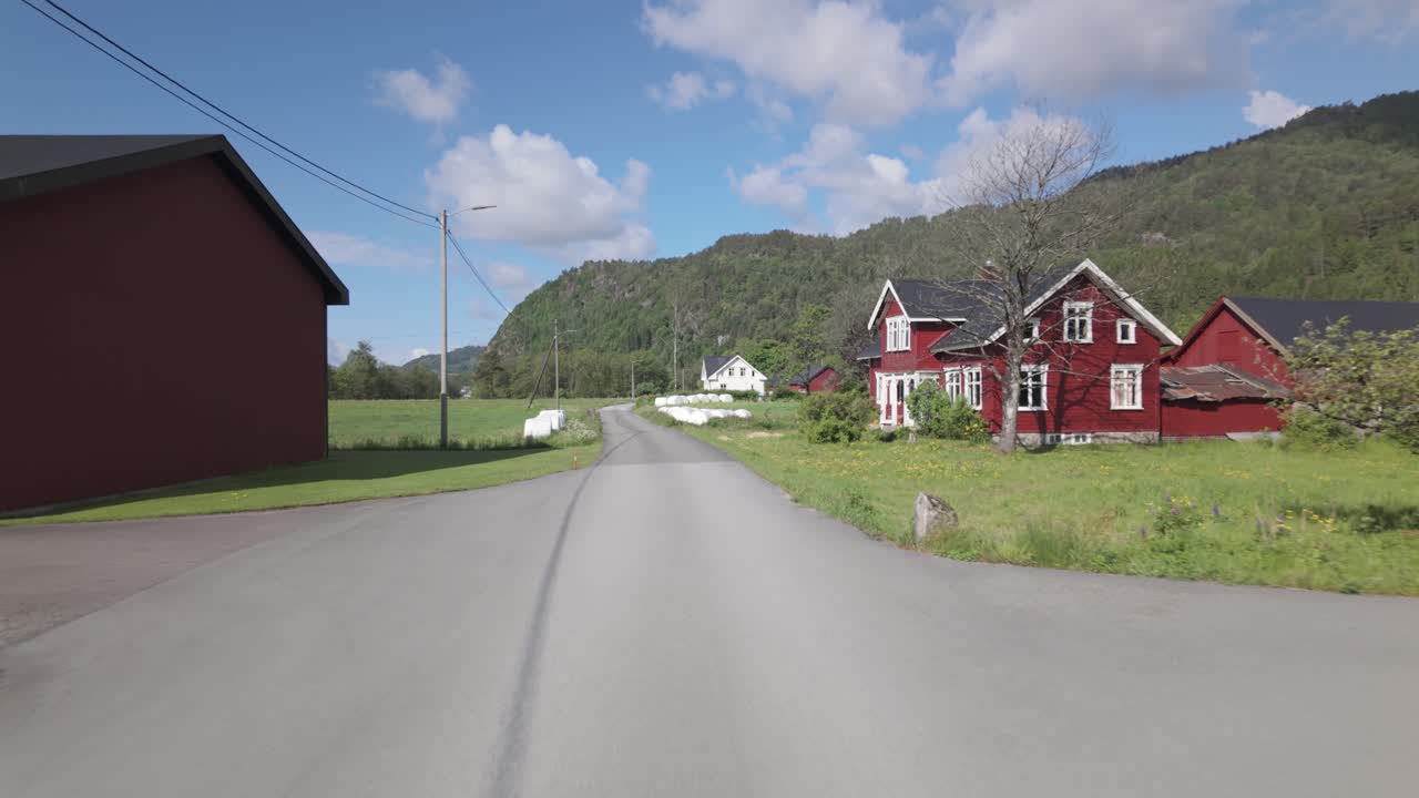 Driving On The Road In The Typical Norwegian Village On A Sunny Day. POV Shot
