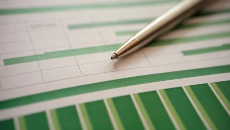 ballpoint pen lying on documents with charts of financial profit growth closeup 4k movie
